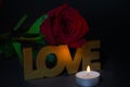 Red rose with candle and love written Royalty Free Stock Photo