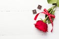 Red rose, chocolates on a white wooden background Royalty Free Stock Photo