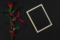 Red rose and empty chalk board on black background. Valentines d