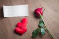 Red rose flower with blank paper and heart shape on wood Royalty Free Stock Photo