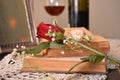 Red rose flower on the books and glass red wine and bottle in background Royalty Free Stock Photo