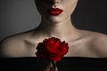 Red Rose Flower and Model Lips Close up Fine Art Portrait. Beauty Model Face and Shoulders Make up. Elegant Mysterious Lady