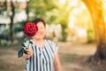 Red rose flower with human hand in Valentine's Day