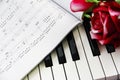 Red rose flower, notes and piano a keys Royalty Free Stock Photo