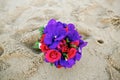 Red rose flower and purple orchid wedding bouquet on sand Royalty Free Stock Photo