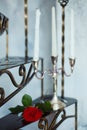 Red rose flower and candles on a metal staircase