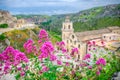 Red rose flowers and blurred background view of Church Chiesa San Pietro Caveoso