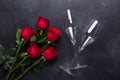 Red rose flowers bouquet, champagne glasses on black stone background Valentine`s day greeting card Copy space Royalty Free Stock Photo