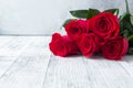 Red rose flowers bouquet on stone background Valentine`s day greeting card White wooden table Royalty Free Stock Photo