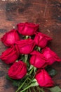 Red rose flowers bouquet on wooden background Valentine`s day greeting card. Copy space. Top view Royalty Free Stock Photo