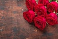 Red rose flowers bouquet on wooden background Valentine`s day greeting card. Copy space. Top view Royalty Free Stock Photo