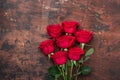 Red rose flowers bouquet on wooden background Valentine`s day greeting card. Copy space. Top view Royalty Free Stock Photo