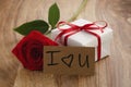 Red rose with gift box and i love you card on wooden table Royalty Free Stock Photo
