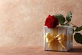 Red rose and gift box on textured