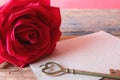 Red rose and heart key shape with brown paper card. Copy space for Valentine& x27;s concept. Copy space. Royalty Free Stock Photo