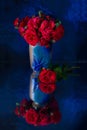 Red rose hip in a blue vase Royalty Free Stock Photo