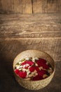 Red rose, Jasmine and popped rice on the calm water surface placed on the wood table Ready for pour water on the hands of revered