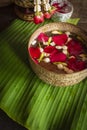 Red rose, Jasmine and popped rice on the calm water surface placed on the wood table Ready for pour water on the hands of revered Royalty Free Stock Photo
