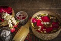 Red rose, Jasmine and popped rice on the calm water surface placed on the wood table Ready for pour water on the hands of revered Royalty Free Stock Photo