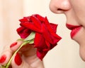 Red rose, red manicure and red lips Royalty Free Stock Photo