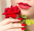 Red rose, red manicure and red lips Royalty Free Stock Photo