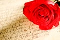 Red rose over a hand written letter Royalty Free Stock Photo