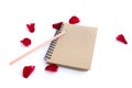 Red rose with petals and brown notebook isolated Royalty Free Stock Photo