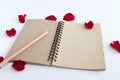 Red rose with petals and brown notebook for valentine background isolated Royalty Free Stock Photo