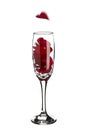 Red rose petals inside champagne glass with falling heart shaped Royalty Free Stock Photo