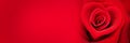 Red rose in the shape of a heart on panoramic red background valentines day web banner Royalty Free Stock Photo