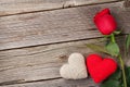 Red rose and Valentines day hearts on wood