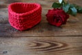 Red rose with water drops and red heart for a gift on a wooden background with copy space for text Royalty Free Stock Photo