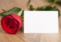 Red rose and blank sheet on wood Royalty Free Stock Photo