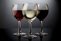 Red, rose and white wine glasses in a black background Royalty Free Stock Photo