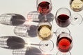 Red, rose and white wine top view in sunlight. Dark shadows Royalty Free Stock Photo