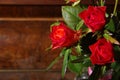 Red roses bouqet on the vintage old wooden piano Royalty Free Stock Photo