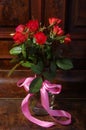 Red roses bouqet on the vintage old wooden piano Royalty Free Stock Photo