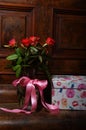 Red roses bouqet on the vintage old wooden piano Royalty Free Stock Photo