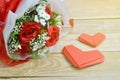 Red roses bouquet and paper hearts shape put on wooden background. Concept for Valentine`s day, Birthday or Wedding Royalty Free Stock Photo