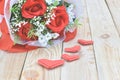 Red roses bouquet and paper hearts shape put on wooden background. Concept for Valentine`s day, Birthday or Wedding Royalty Free Stock Photo