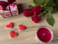 Red roses with red candle red hearts and pink gift