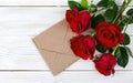 Red roses and envelope on white wooden background, Top view with copy space, Valentines Day, International Women's Day, Mothers Royalty Free Stock Photo