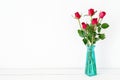 Red roses flower bouquet in green vase on white background Royalty Free Stock Photo