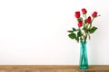 Red roses flower bouquet in green vase on white background Royalty Free Stock Photo