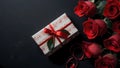 Red roses and a gift box on a dark background Royalty Free Stock Photo