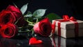 Red roses and gift box on a dark surface Royalty Free Stock Photo