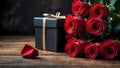 Red roses and gift box on a dark wooden surface Royalty Free Stock Photo