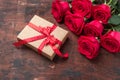 Red roses, gift box and decorative hearts on wooden background. Valentine`s day concept Royalty Free Stock Photo