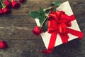 Red roses and gift box over wooden table top view Royalty Free Stock Photo