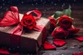 Red roses and gift box with water drops on wet wooden surface. Royalty Free Stock Photo